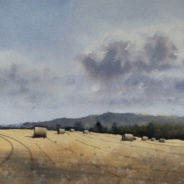 Watercolour painting of a Sussex field with hay bales and distant trees and hills in the background by artist John Haywood